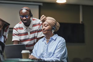 Multiethnic team working together in an office, showcasing diversity and collaboration.
